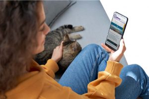 Woman w cell phone and cat image