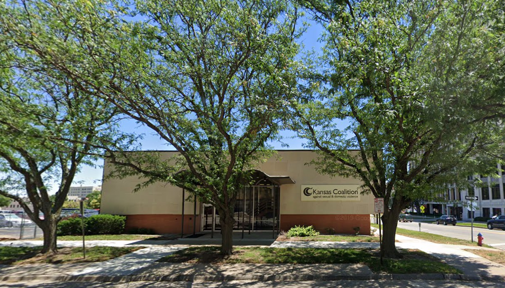 outside of building with 3 blooming trees in front